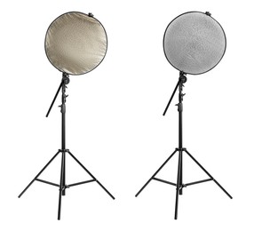 Image of Tripods with reflectors on white background. Professional photographer's equipment
