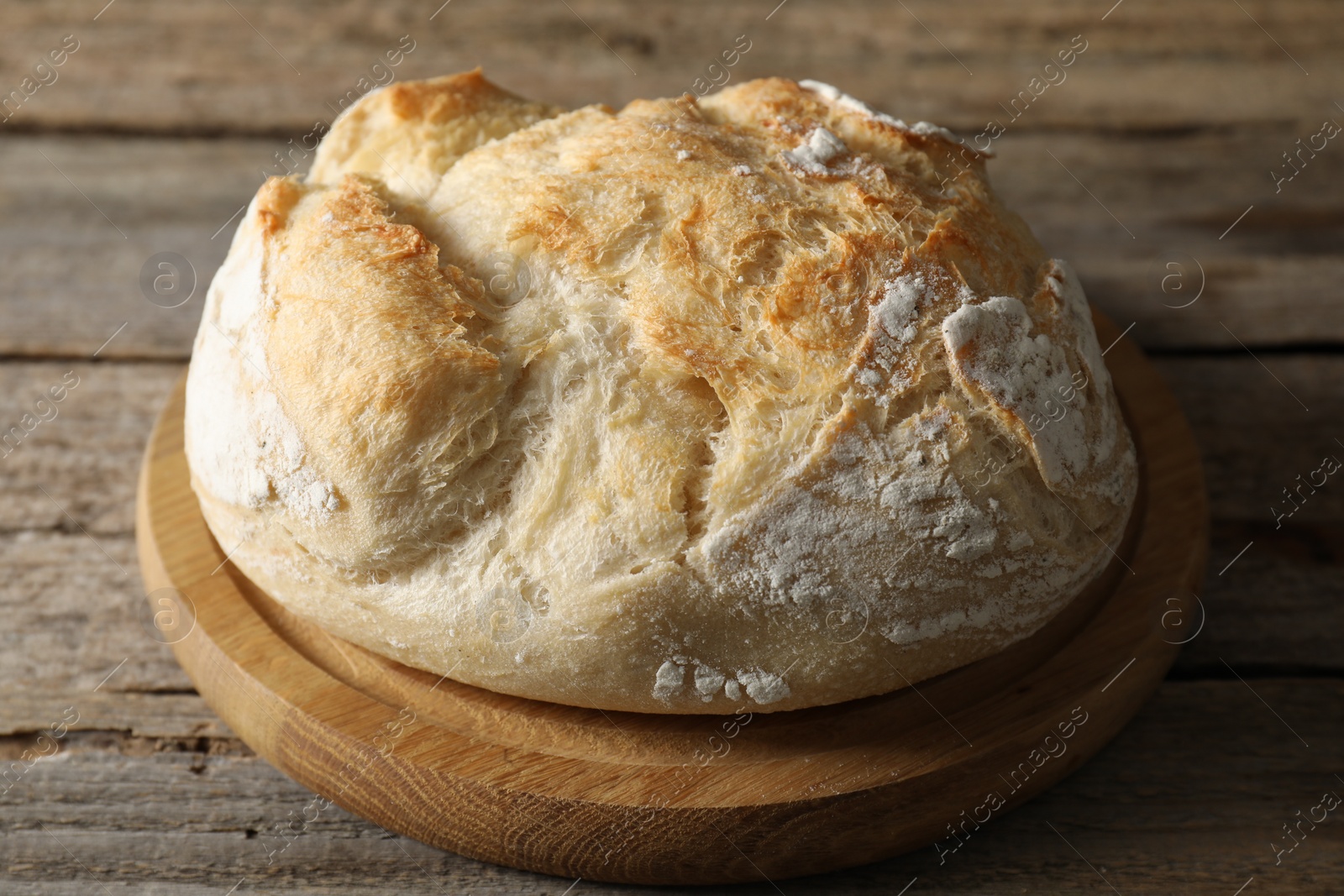 Photo of Freshly baked sourdough bread on wooden table