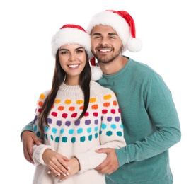 Lovely young couple in Santa hats on white background. Christmas celebration