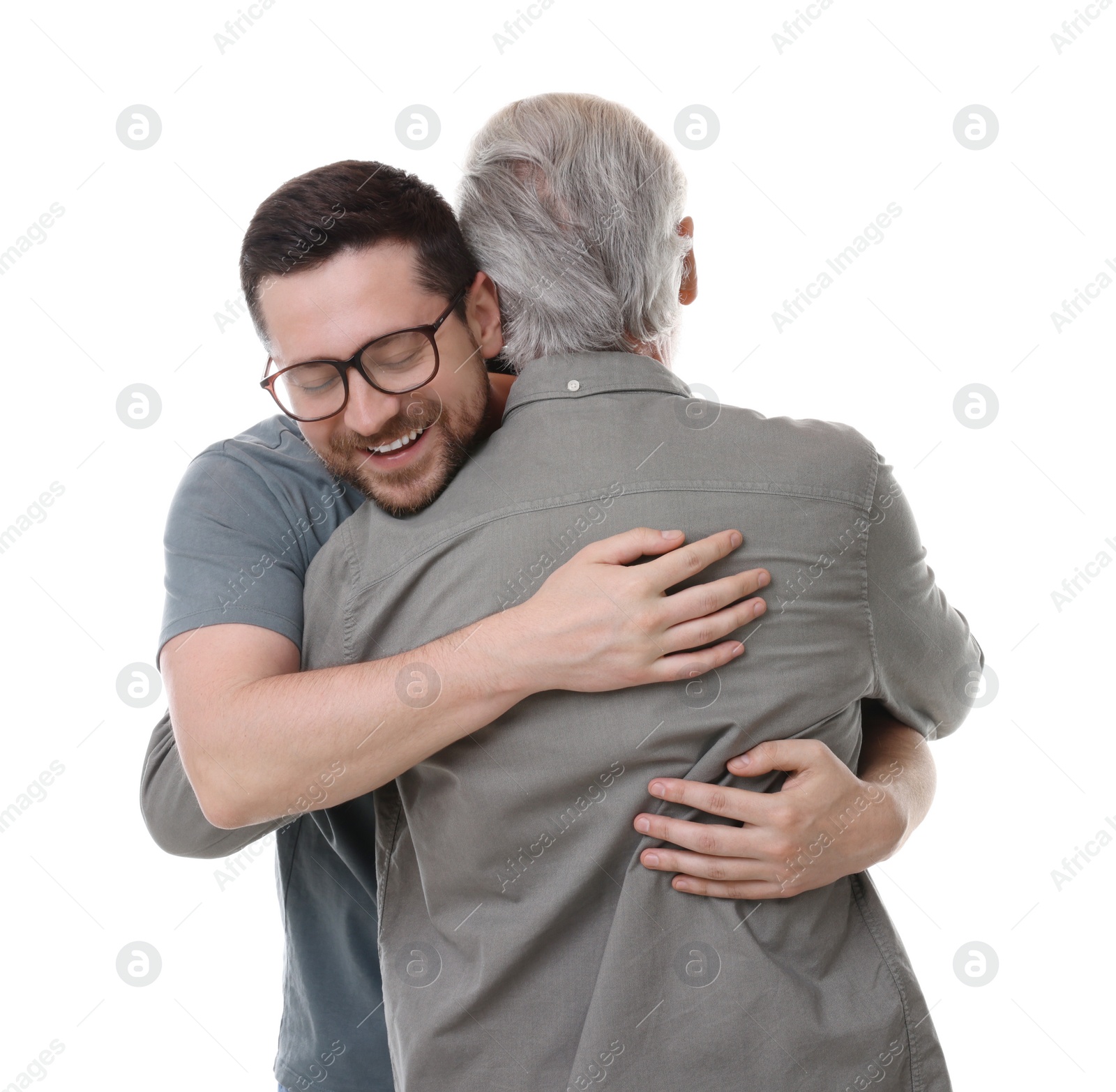Photo of Happy son and his dad hugging on white background