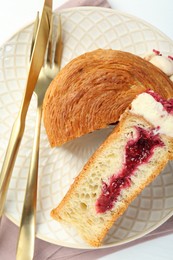 Round croissant with jam on white table, top view. Tasty puff pastry