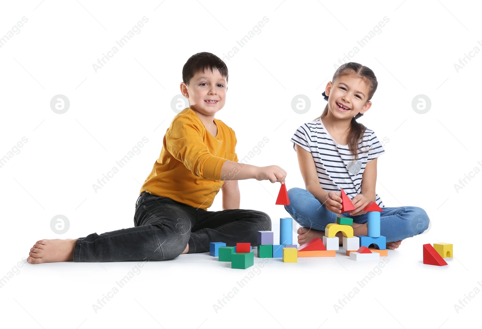 Photo of Cute children playing with colorful blocks on white background