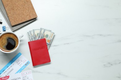 Flat lay composition with passport, dollars and tickets on white marble table, space for text. Business trip