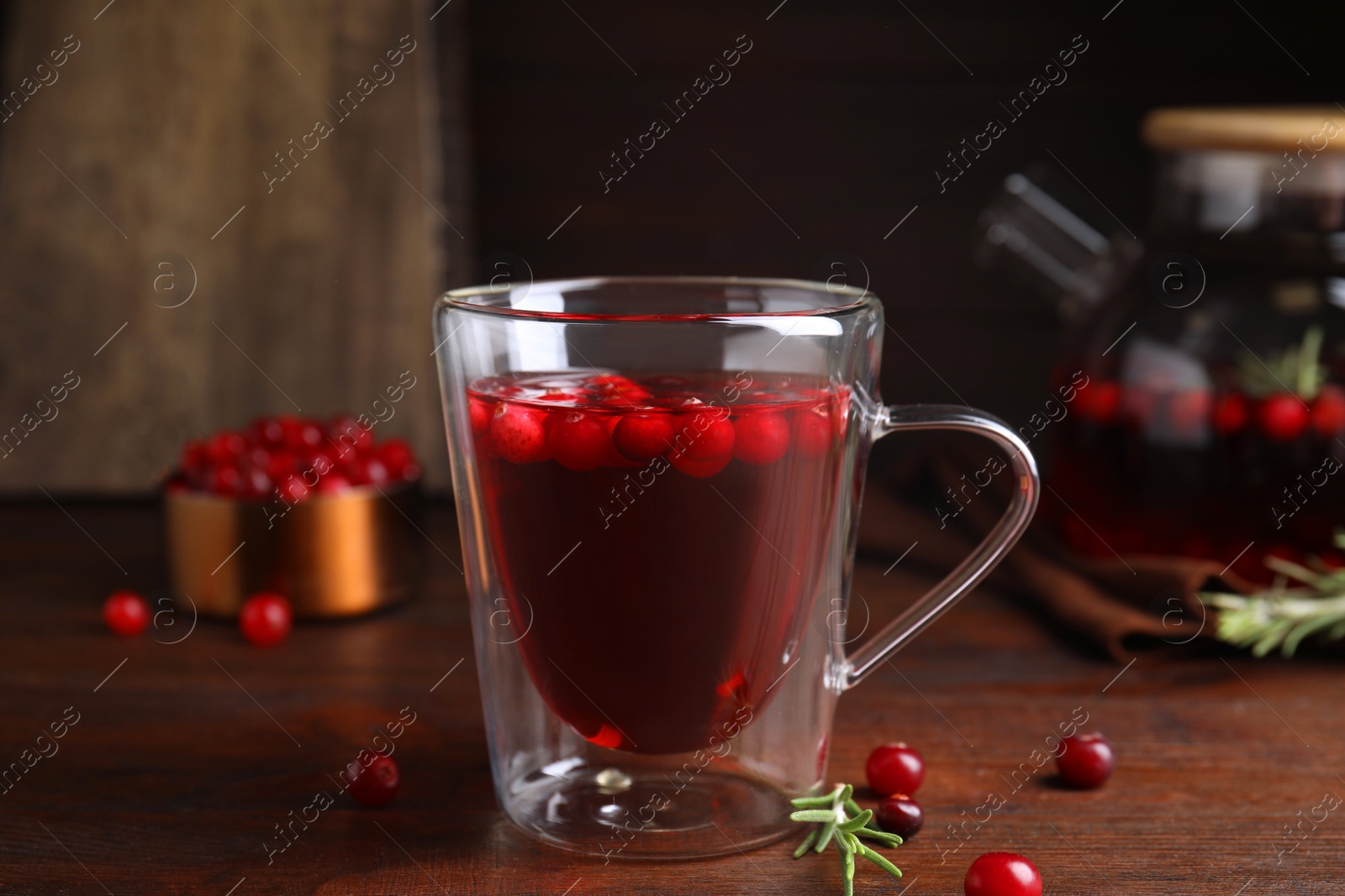 Photo of Tasty hot cranberry tea on wooden table