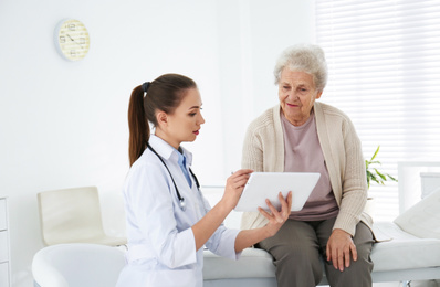 Senior woman visiting doctor in modern office