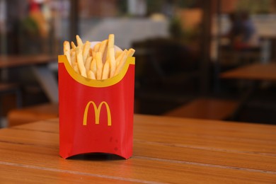 MYKOLAIV, UKRAINE - AUGUST 11, 2021: Big portion of McDonald's French fries on table in cafe. Space for text
