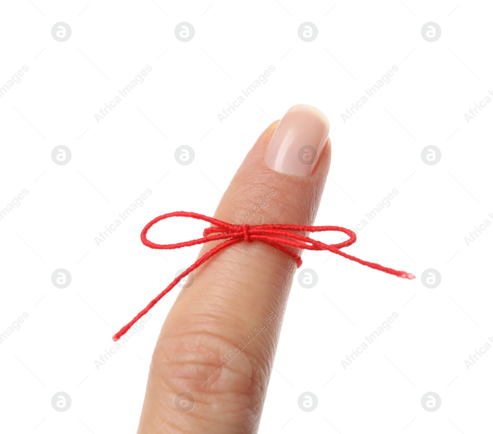 Photo of Woman showing index finger with tied red bow as reminder on white background, closeup
