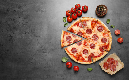 Photo of Flat lay composition with hot pepperoni pizza on grey  table. Space for text