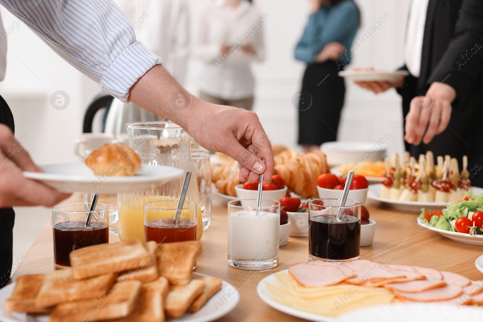 Photo of Coworkers having business lunch in restaurant, closeup