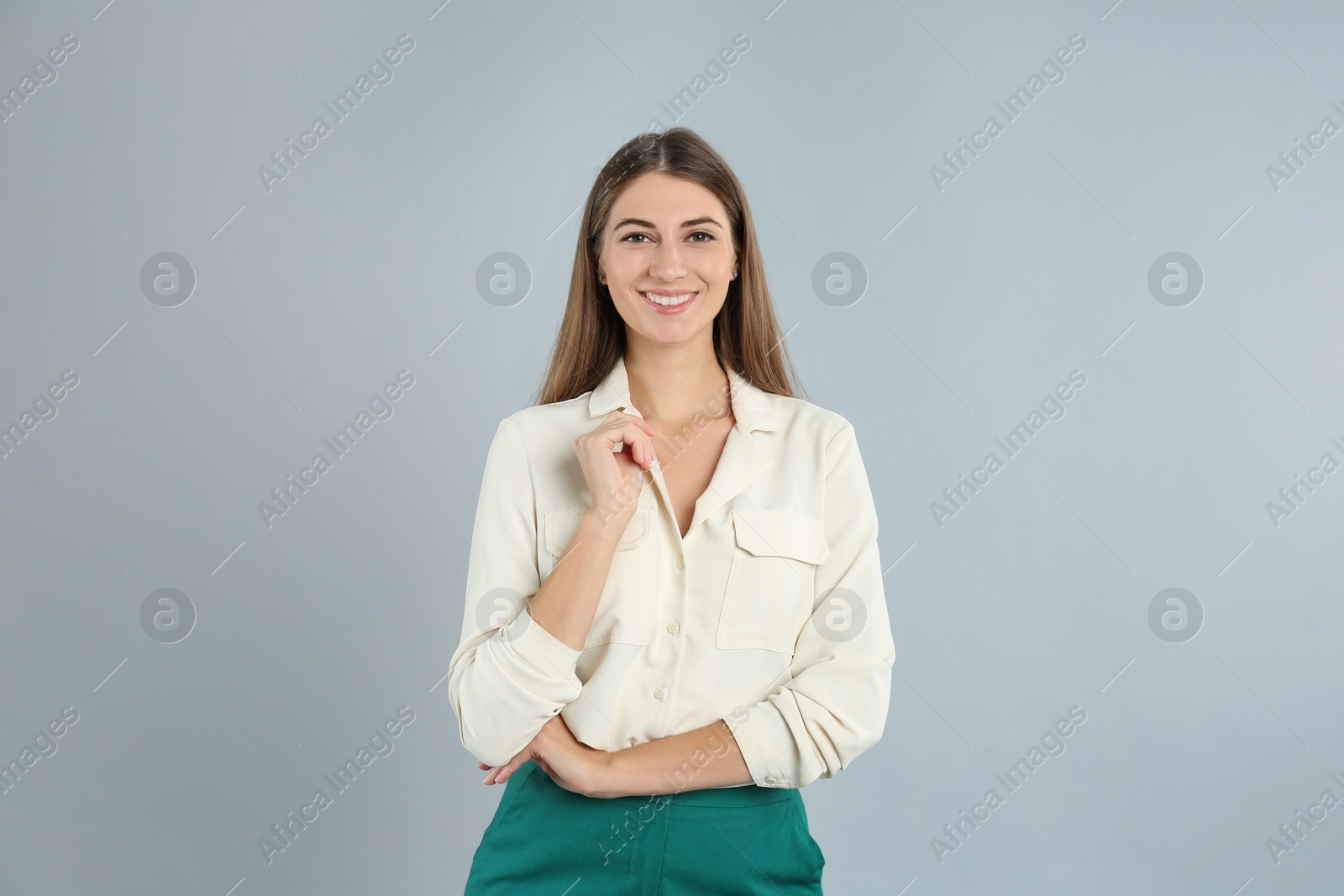 Photo of Portrait of beautiful young businesswoman on light grey background