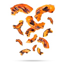 Slices of grilled bell peppers in air on white background