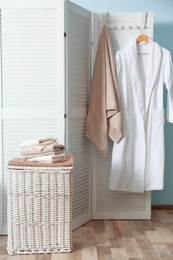 Photo of Bathroom interior with laundry basket and soft towels