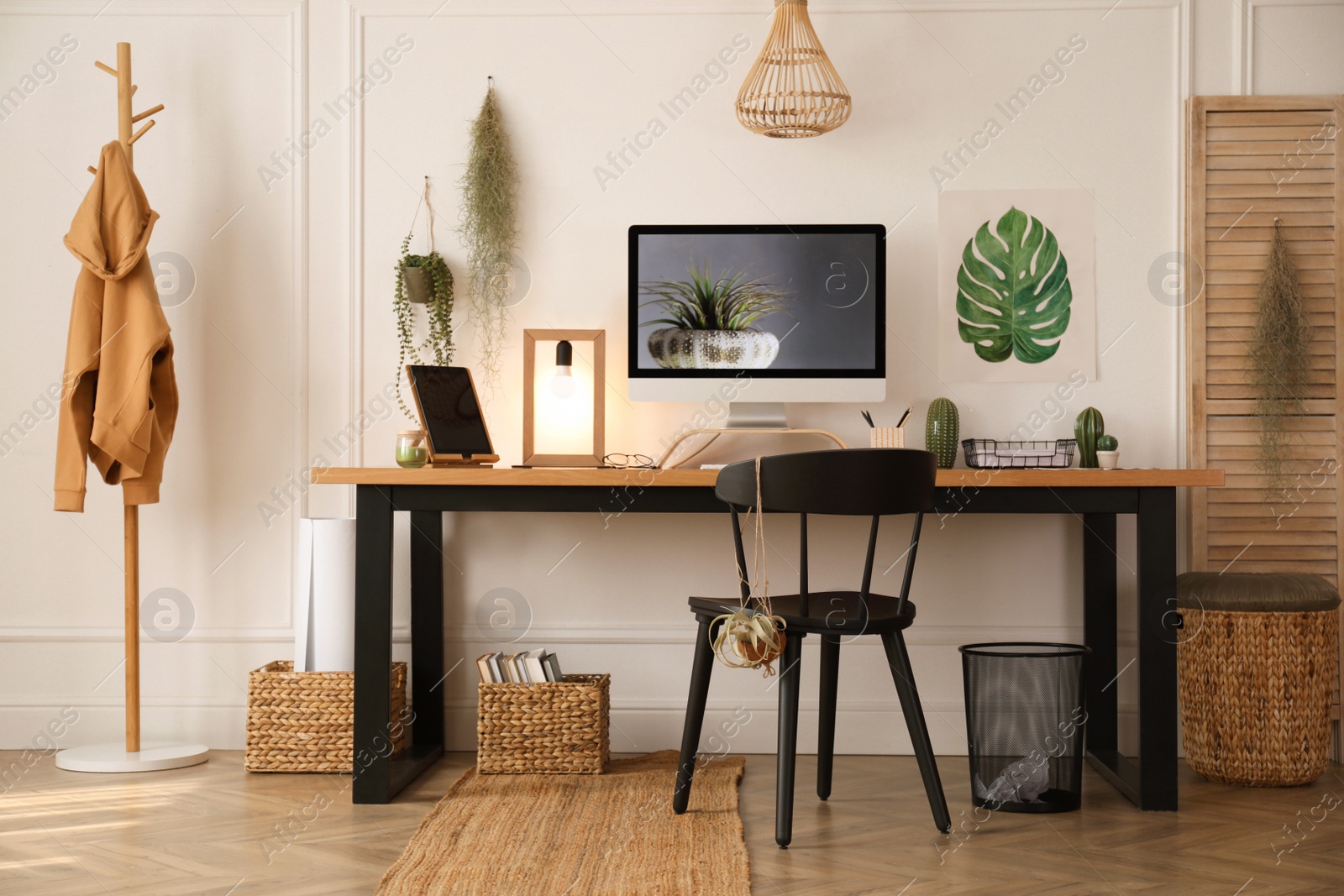 Photo of Modern workplace with computer in room. Interior design