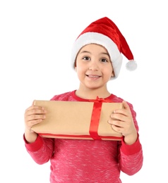 Photo of Cute little child in Santa hat with Christmas gift on white background