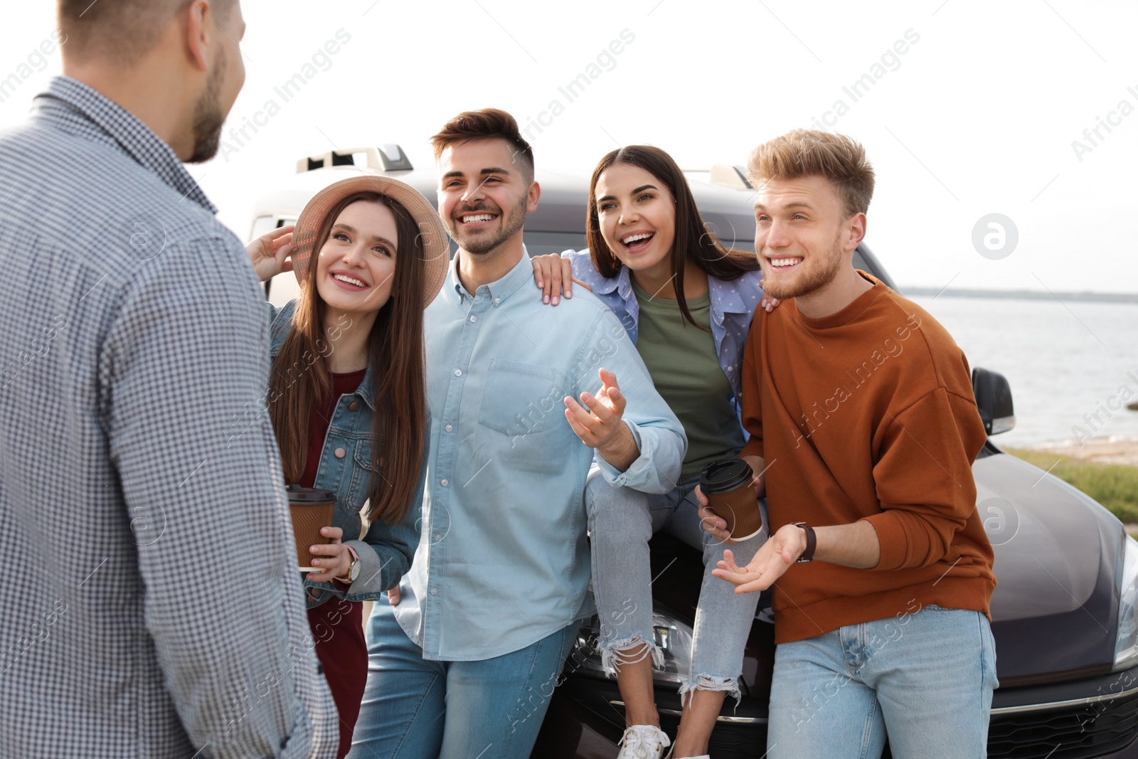 Photo of Group of happy people spending time together outdoors