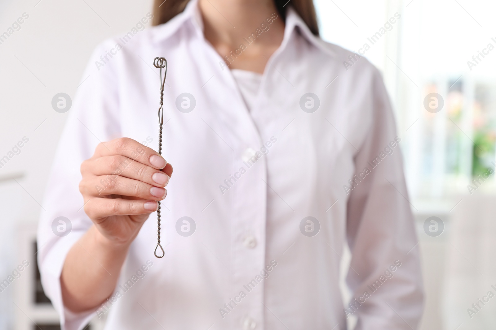 Photo of Speech therapist with logopedic probe in clinic, closeup. Space for text