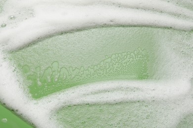 White washing foam on olive background, top view