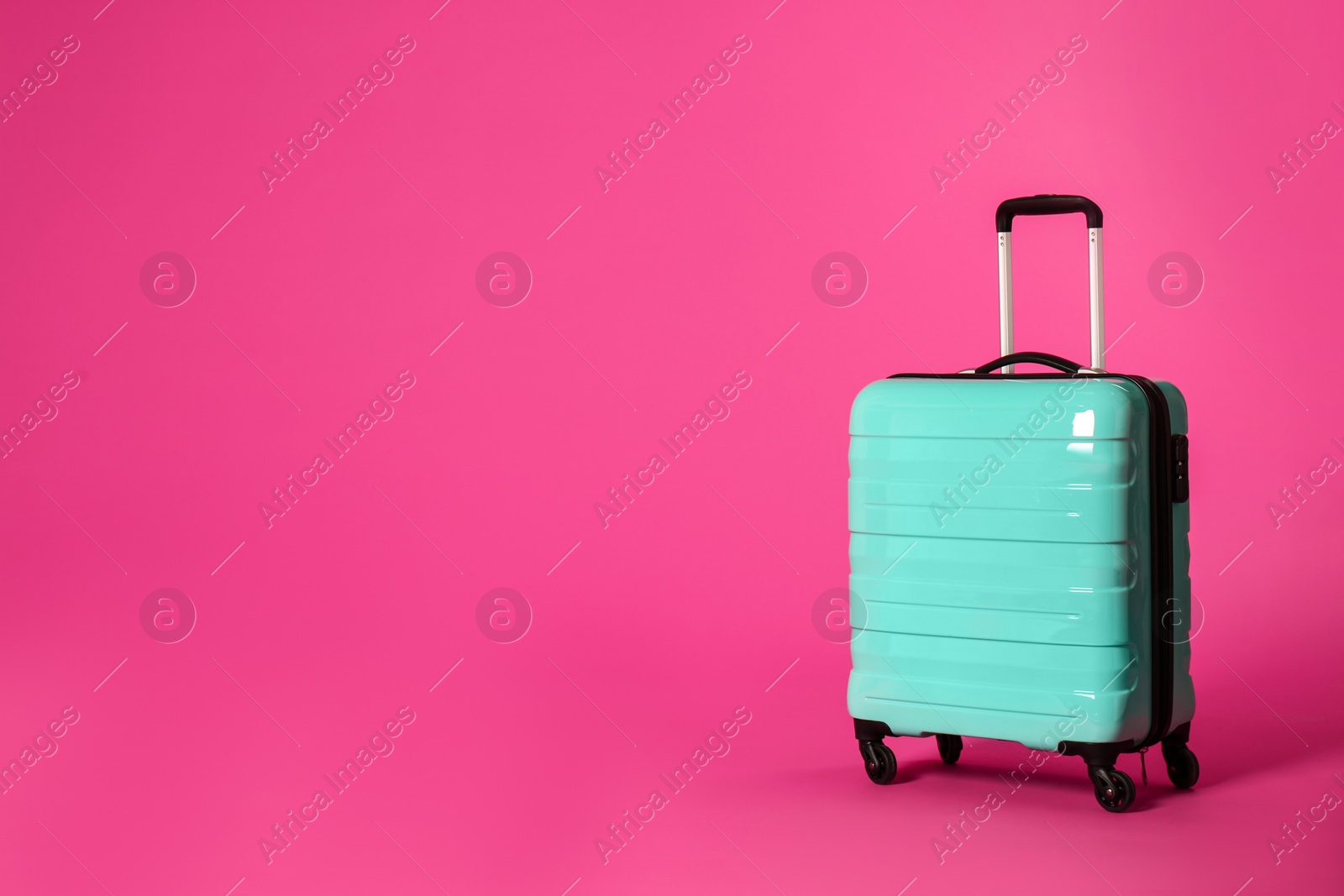 Photo of Stylish suitcase on color background. Space for text