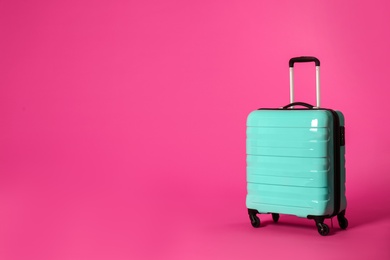 Stylish suitcase on color background. Space for text