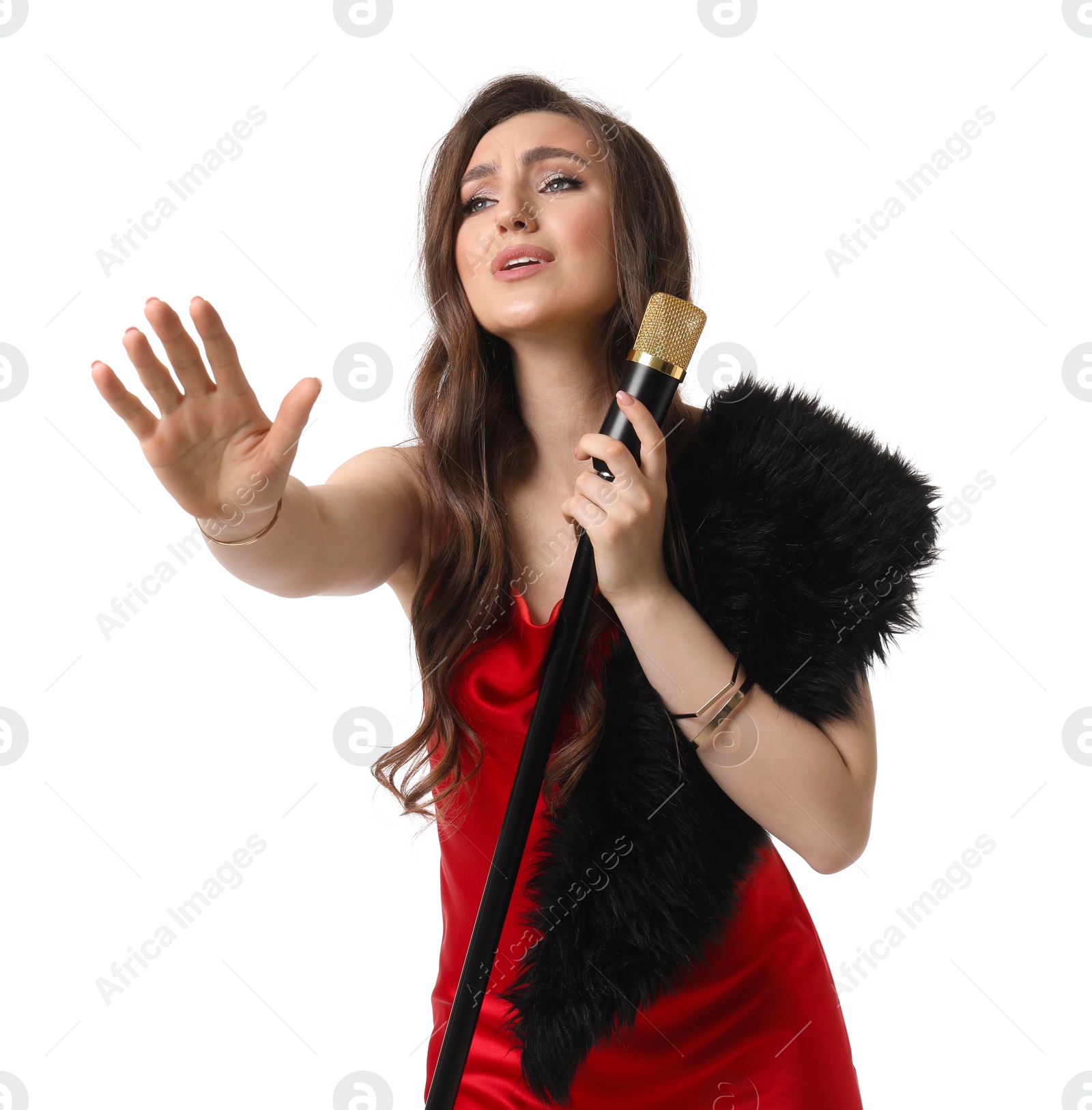 Photo of Beautiful young woman in stylish red dress with microphone singing on white background