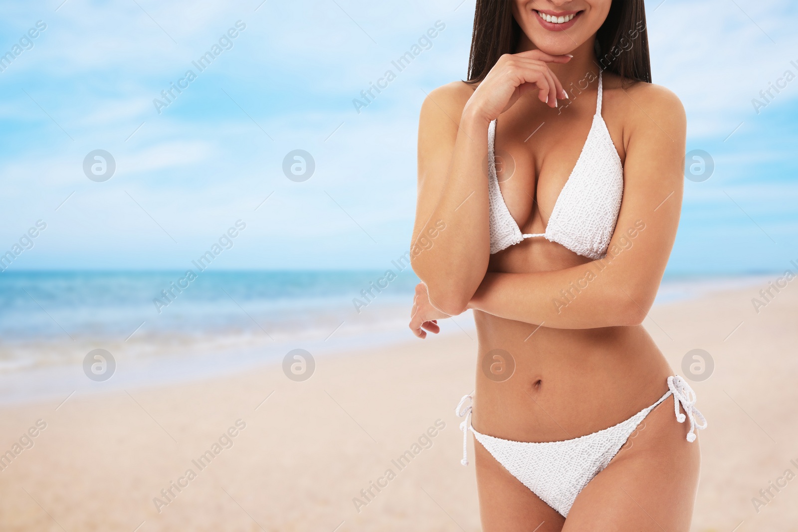 Image of Pretty sexy woman with slim body in stylish bikini at beach on sunny day, closeup. Space for text