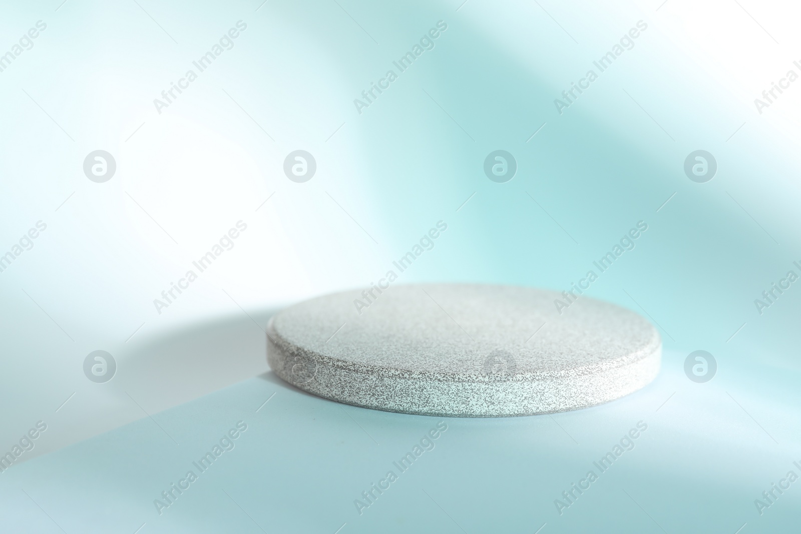 Photo of Presentation of product. Stone podium on light blue background, space for text
