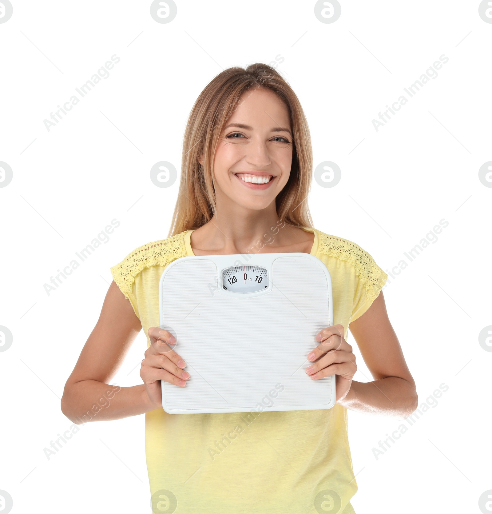 Photo of Happy slim woman satisfied with her diet results holding bathroom scales on white background