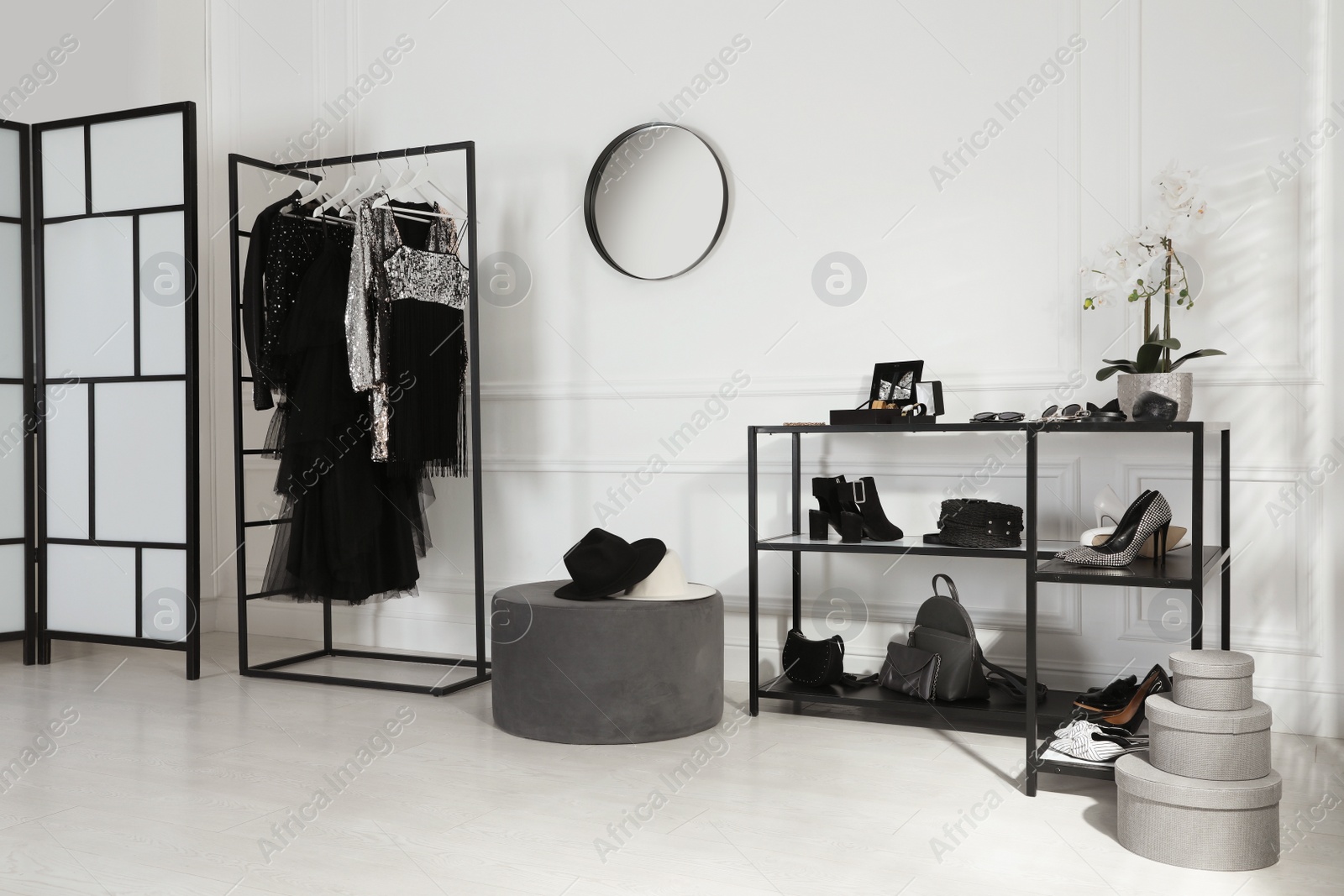 Photo of Stylish dressing room interior with trendy clothes, shoes and accessories