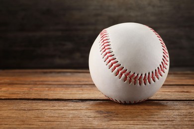 Baseball ball on wooden background, space for text