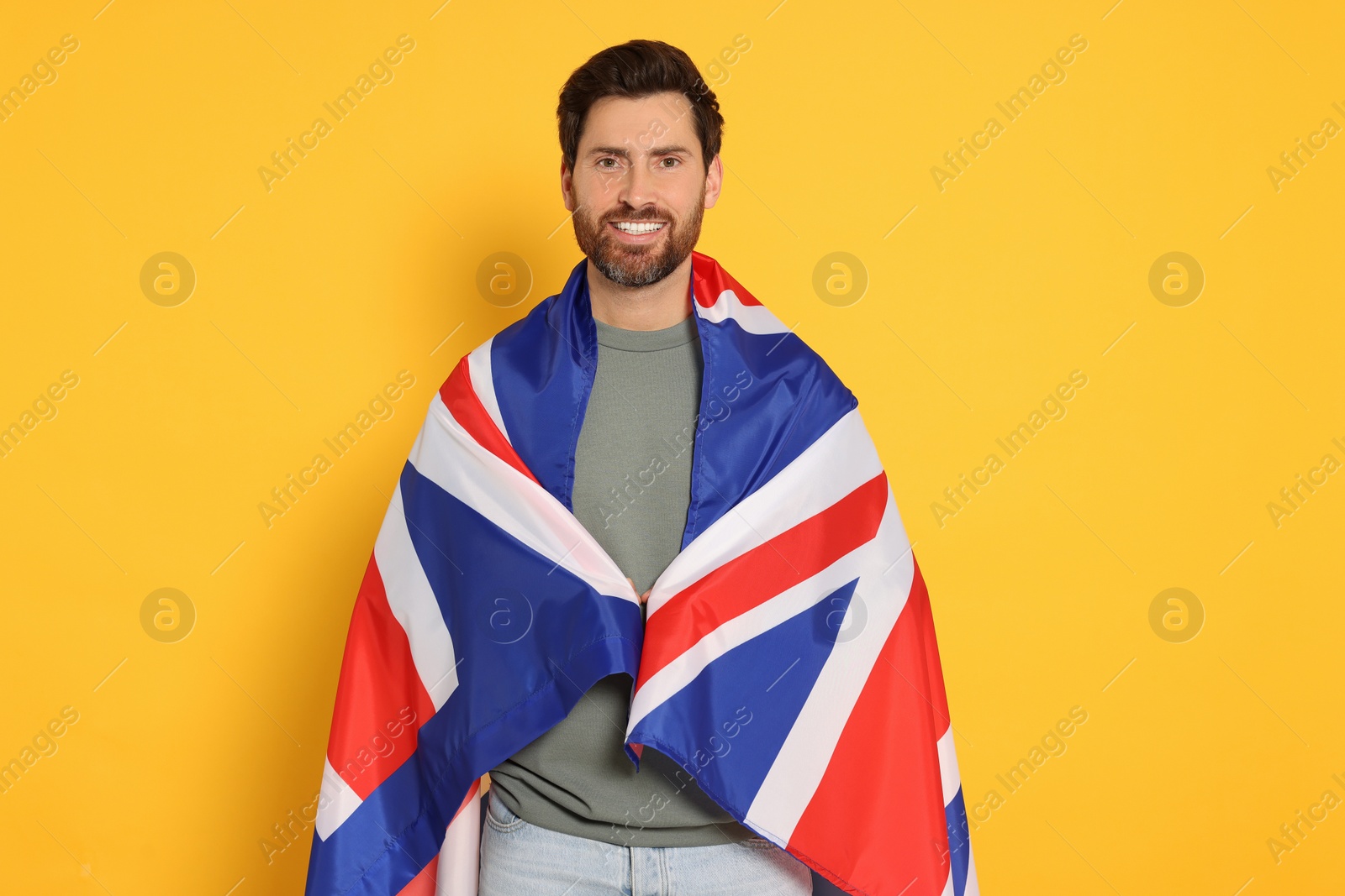 Photo of Man with flag of United Kingdom on yellow background