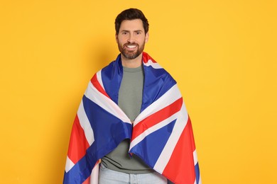 Man with flag of United Kingdom on yellow background