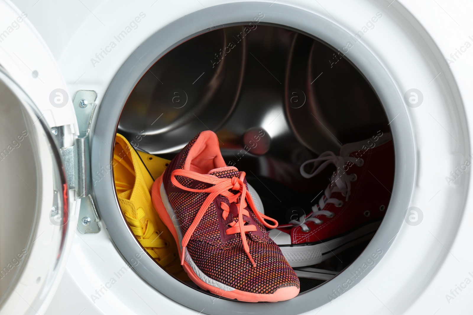 Photo of Clean sports shoes in washing machine drum