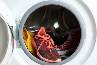 Photo of Clean sports shoes in washing machine drum