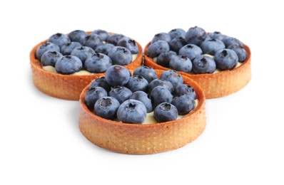 Photo of Tartlets with fresh blueberries isolated on white. Delicious dessert