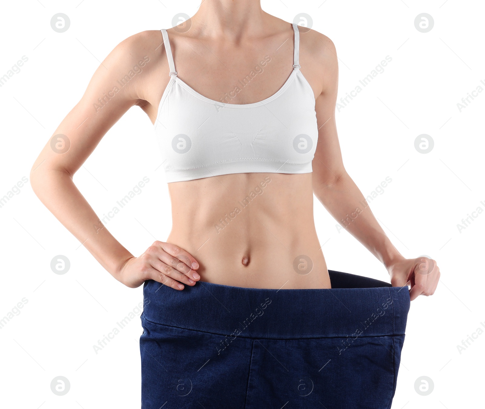 Photo of Young slim woman wearing oversized jeans on white background, closeup