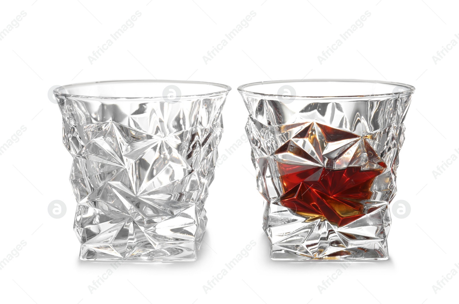 Photo of Empty and full whiskey glasses on white background