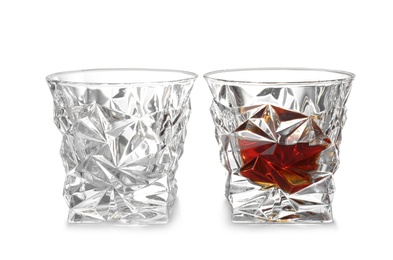 Photo of Empty and full whiskey glasses on white background