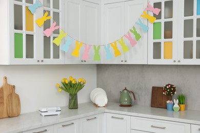 Colorful Easter decor and yellow tulips in kitchen