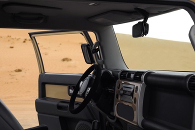 Photo of Modern car in desert, view from passenger seat