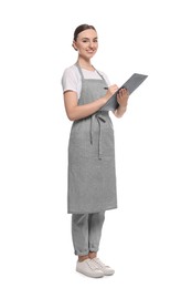 Photo of Beautiful young woman in clean apron with clipboard on white background