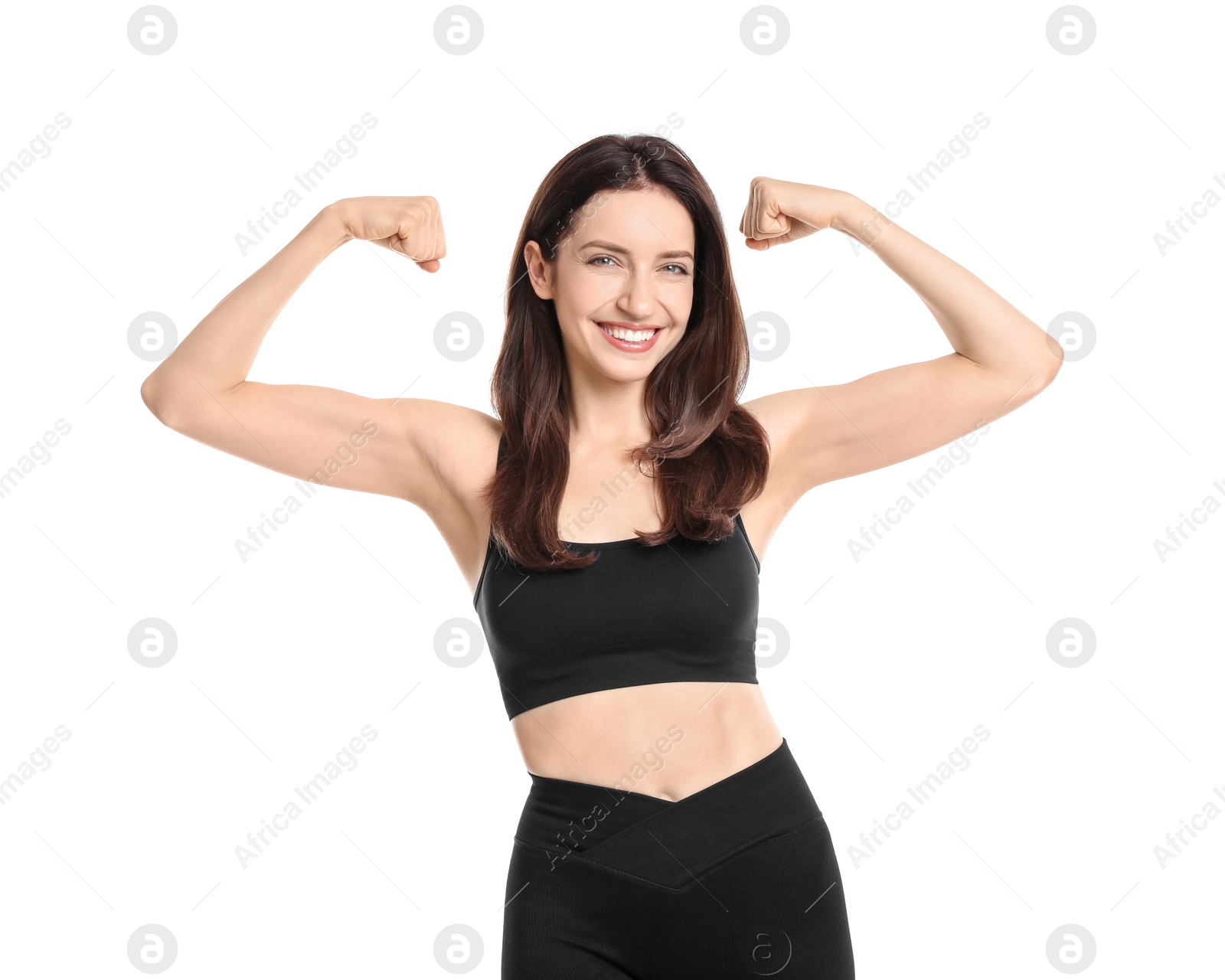 Photo of Happy young woman with slim body showing muscles on white background