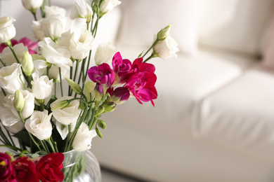 Photo of Beautiful bouquet with spring freesia flowers in light room, closeup. Space for text