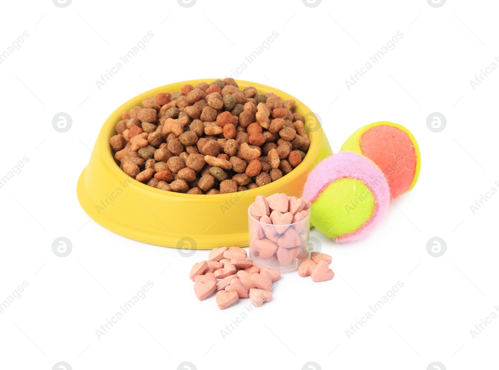 Photo of Dry pet food in bowl, vitamins and toys isolated on white