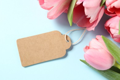 Photo of Happy Mother's Day. Beautiful tulips with blank card on light background, flat lay