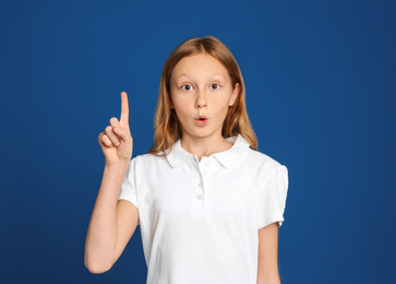 Photo of Portrait of emotional preteen girl on blue background