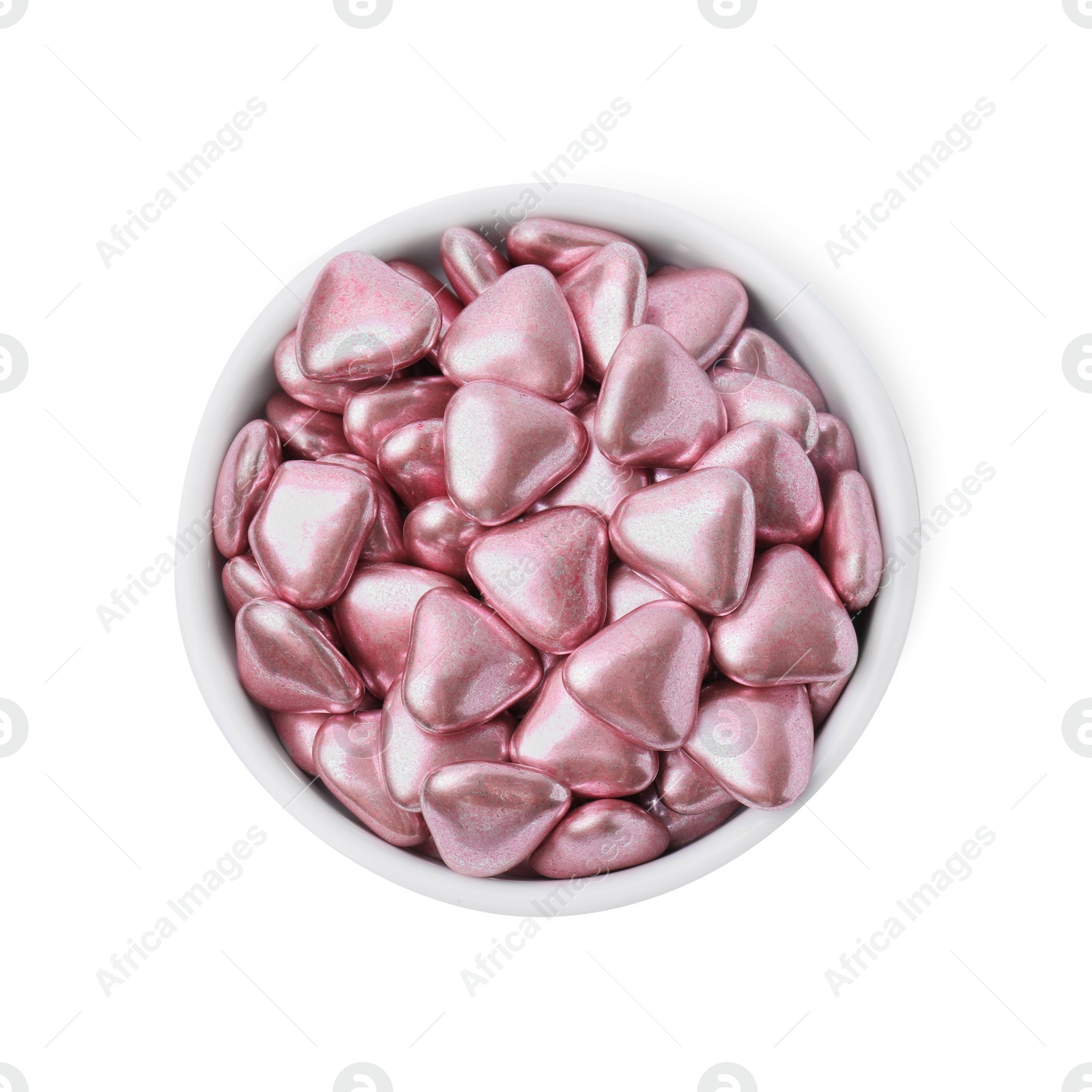 Photo of Bowl with delicious heart shaped candies on white background, top view