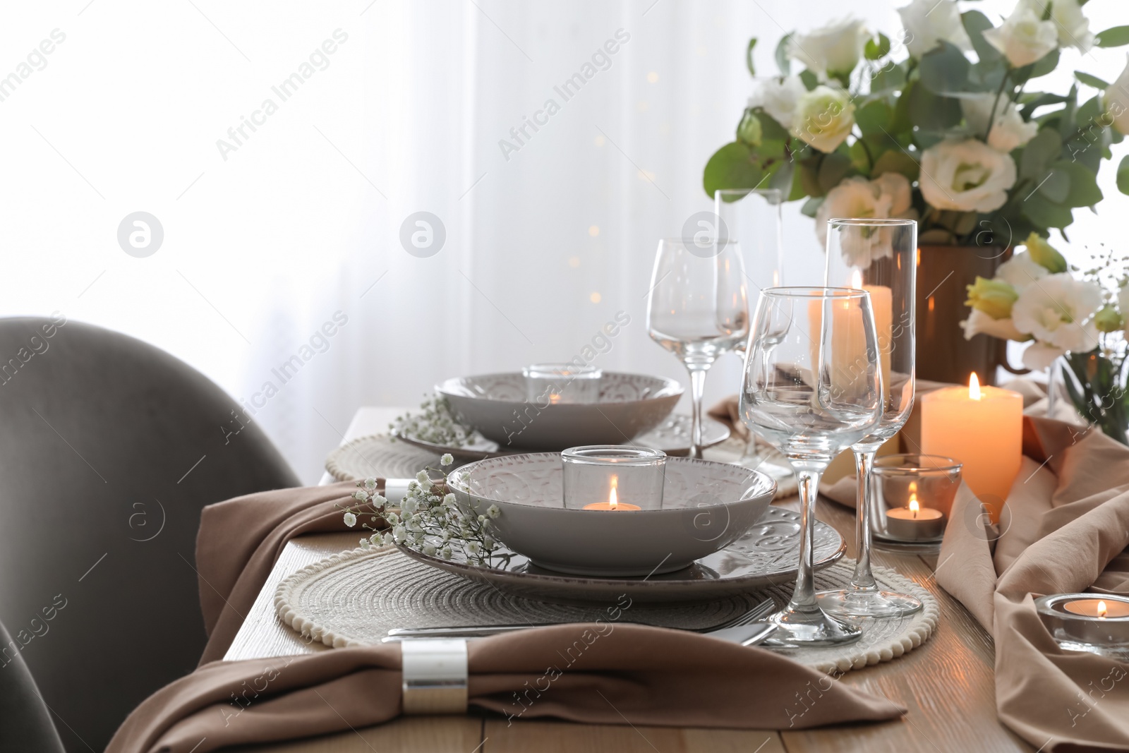 Photo of Festive table setting with beautiful floral decor in restaurant