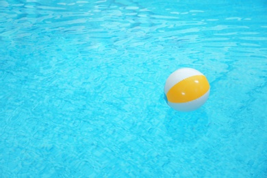 Photo of Colorful inflatable ball floating on water in swimming pool