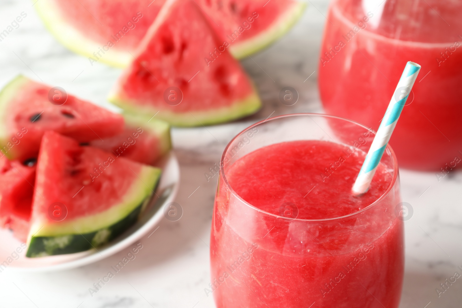 Photo of Tasty summer watermelon drink in glass on table, closeup