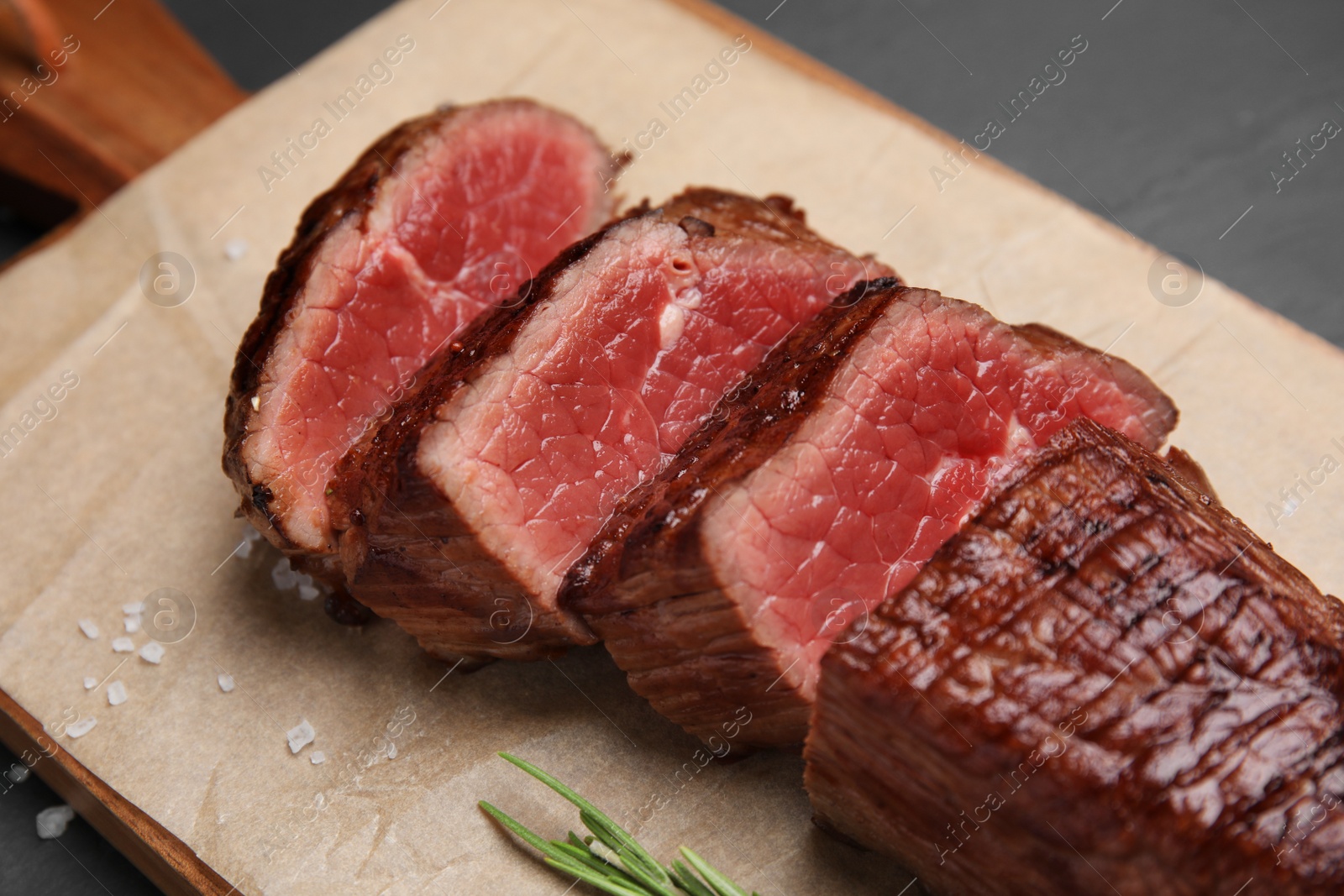 Photo of Delicious sliced beef tenderloin on table, closeup